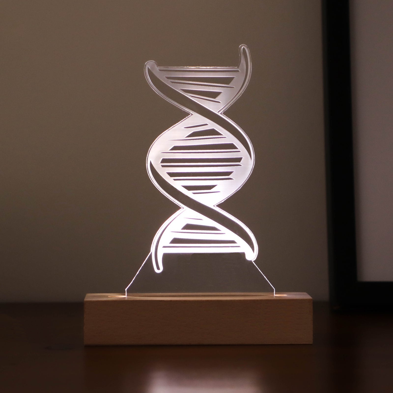 3D illusion lamp featuring a detailed DNA double helix design, illuminated in a white tone, personalized with a name, perfect as a unique and thoughtful gift for geneticists, scientists, or medical professionals specializing in human genome research