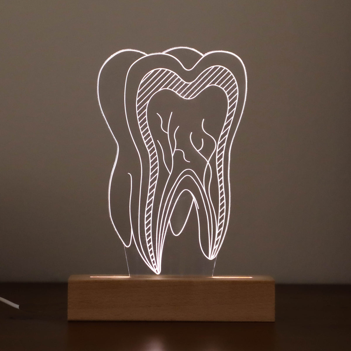Unique 3D illusion lamp showcasing a glowing tooth design, a thoughtful gift for dentists or dental professionals