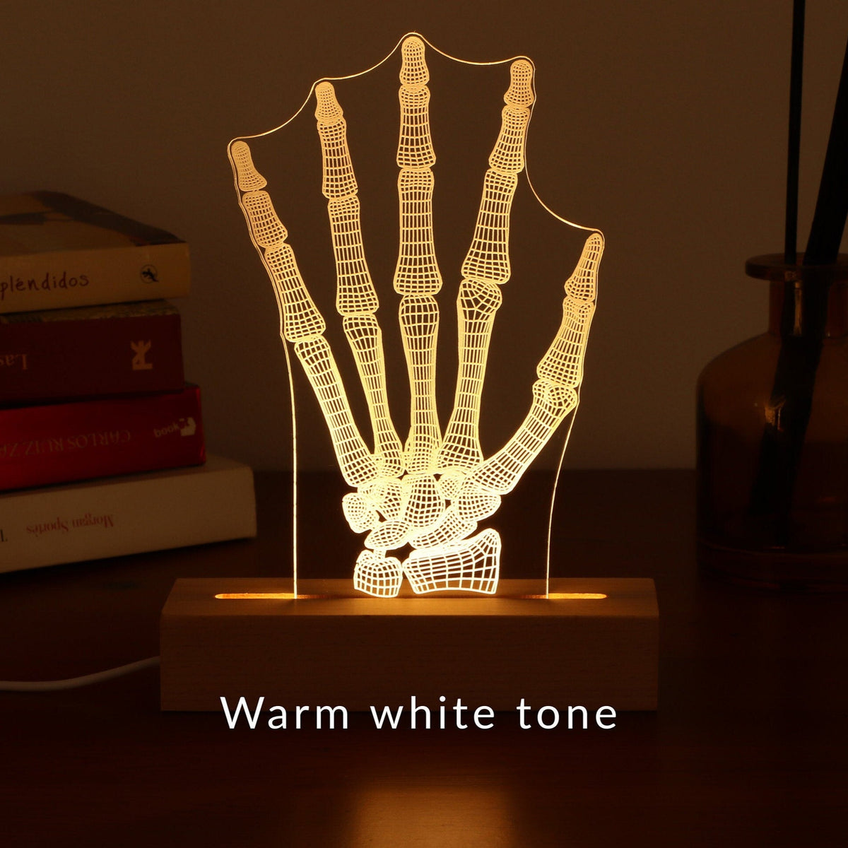 3D illusion lamp featuring a detailed human hand bone anatomy design, illuminated in a warm white tone, perfect as a unique and thoughtful gift for orthopedic specialists, physiotherapists, or medical professionals focusing on hand health.
